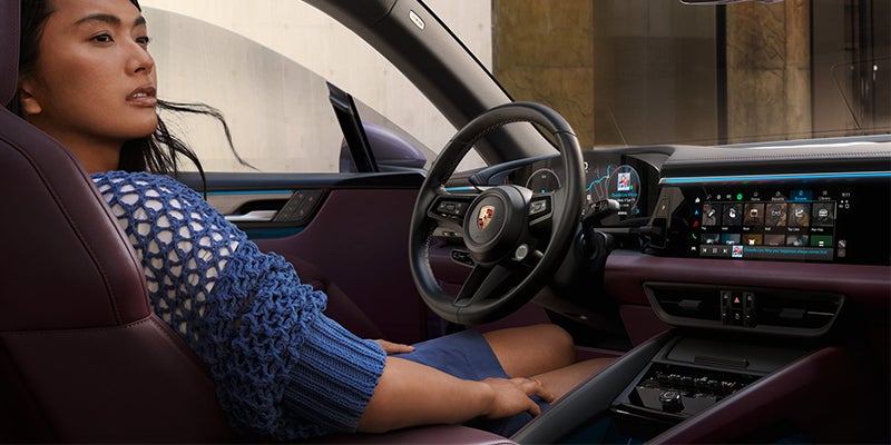 Lady sitting in 2024 Porsche Macan EV drivers seat